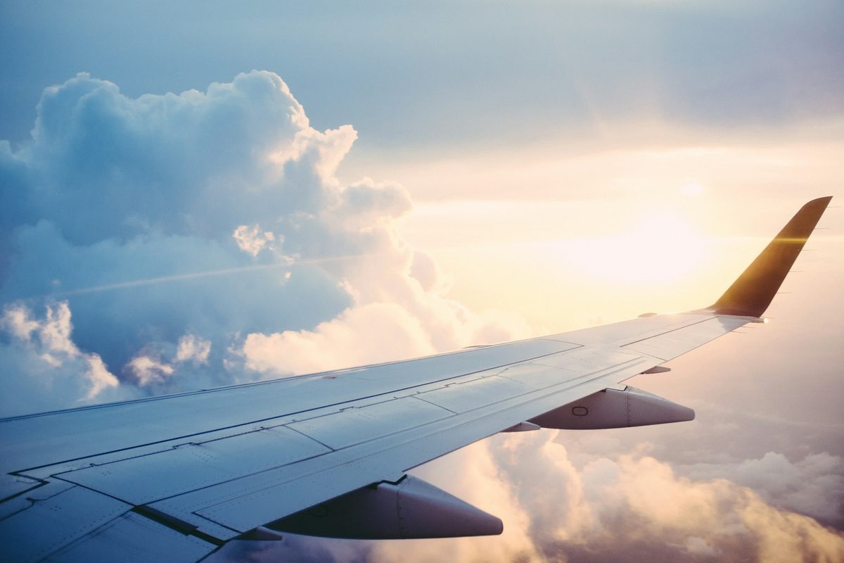 Aircraft wing above the clouds — charter brokerage