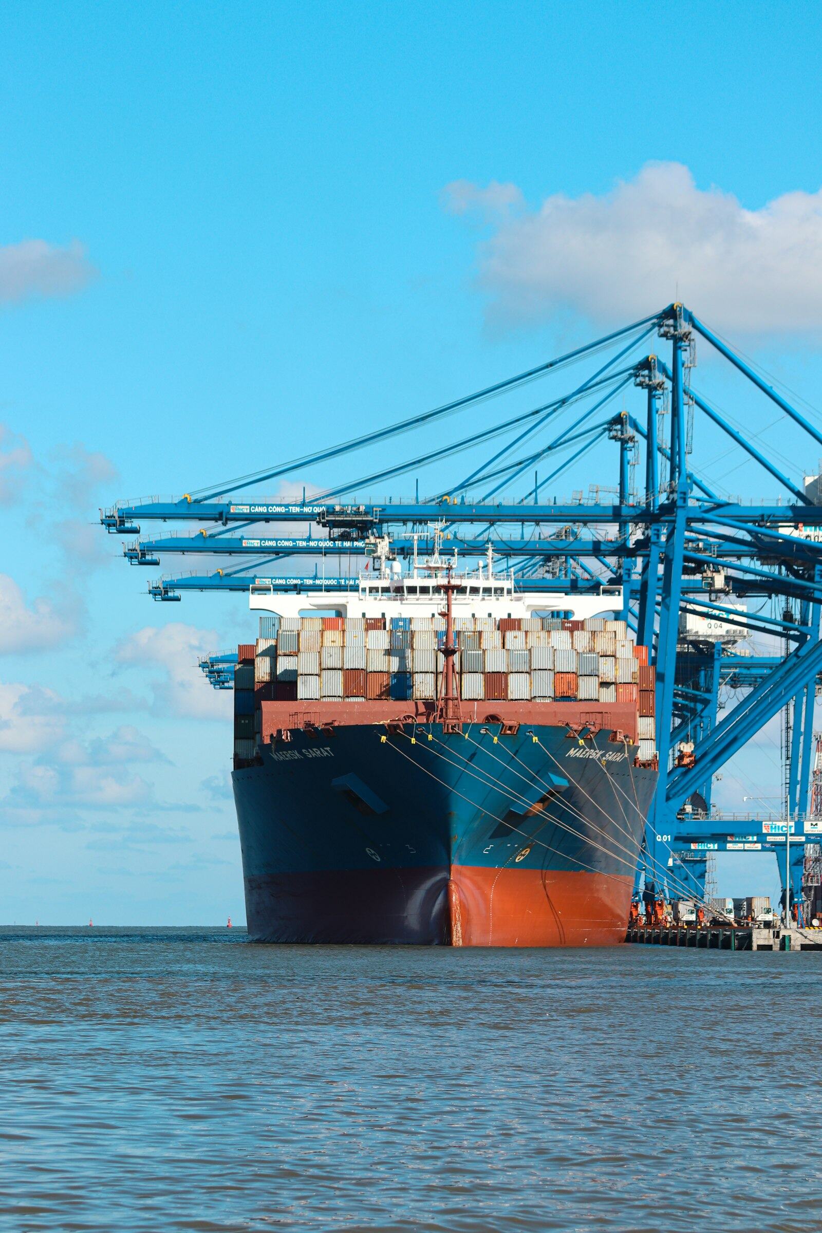Container cargo vessel loading at port — physical commodity trading